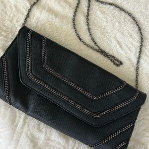 Black vegan leather clutch.  Excellent condition, cute bag!